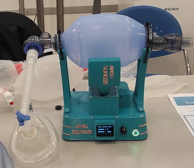 The teal Ambu Squeeze device holding an ambu bag
