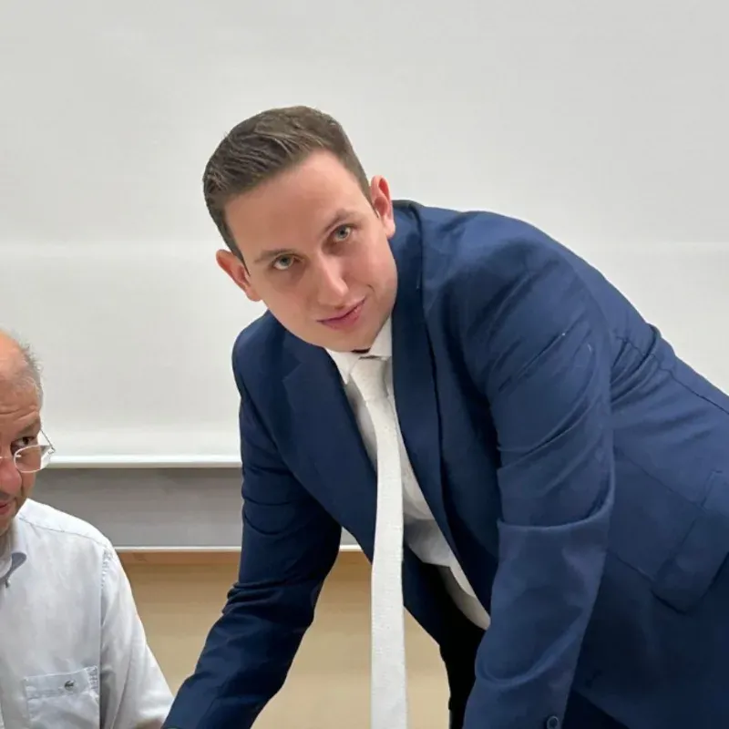 Sotiris Kalaitzakis leaning over a desk at an event