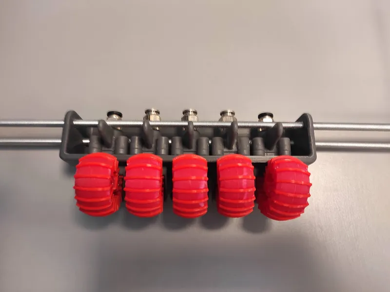 A row of five SoftER actuators mounted on a rail